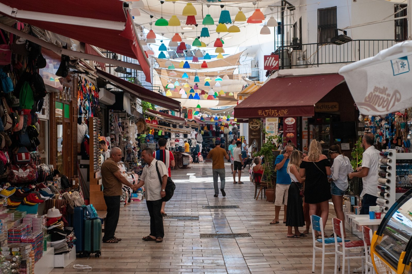 People and locals walk and shop on a shopping street near the promenade of Bodrum, August 23, 2019. (iStock Photo)