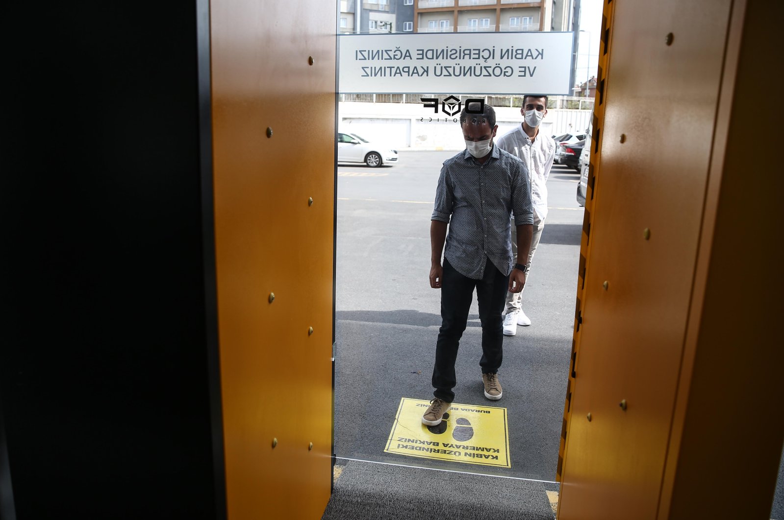 A man is seen in front of a smart disinfection and sanitation cabin developed by DOF Robotics. (AA Photo)