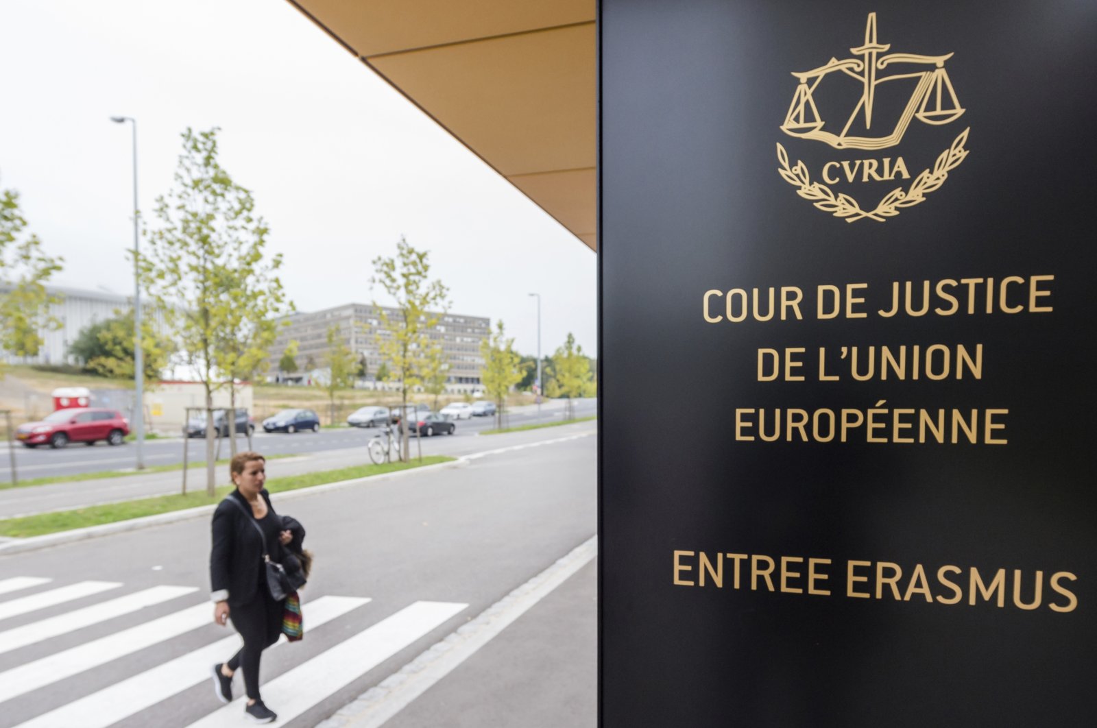 In this Oct. 5, 2015 file photo, a woman walks by the entrance to the European Court of Justice in Luxembourg. (AP Photo)