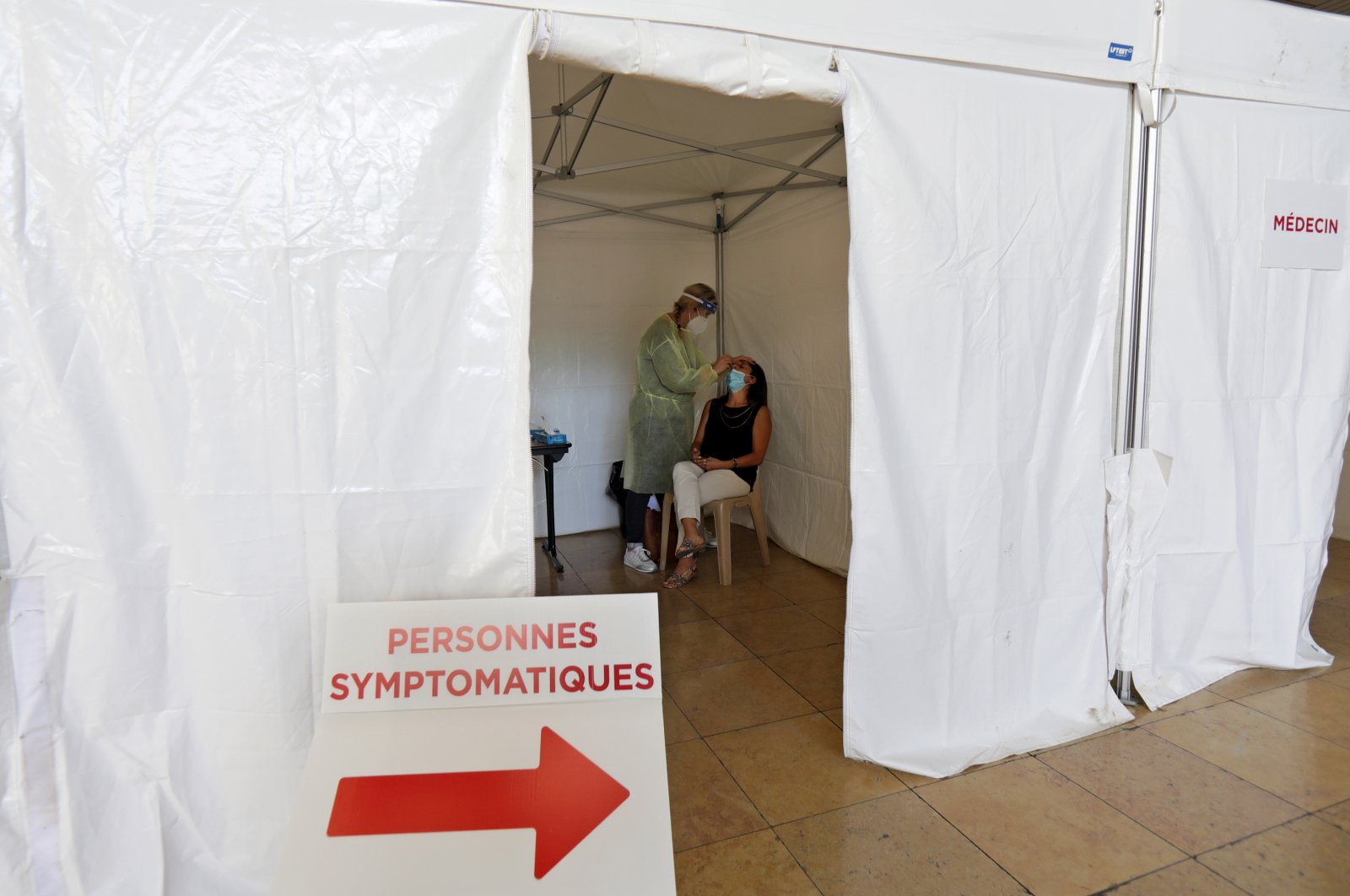 A medical worker, wearing protective suit and face mask, administers a nasal swab to a patient in a testing site, Nice, southern France Sept. 7, 2020. (REUTERS Photo)