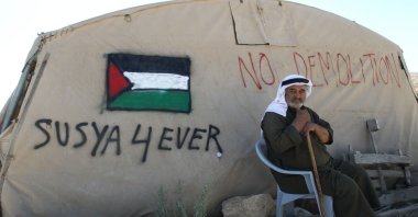 A Palestinian man sits outside his tent in the southern West Bank village of Susya, July 22, 2015. (AFP Photo)
