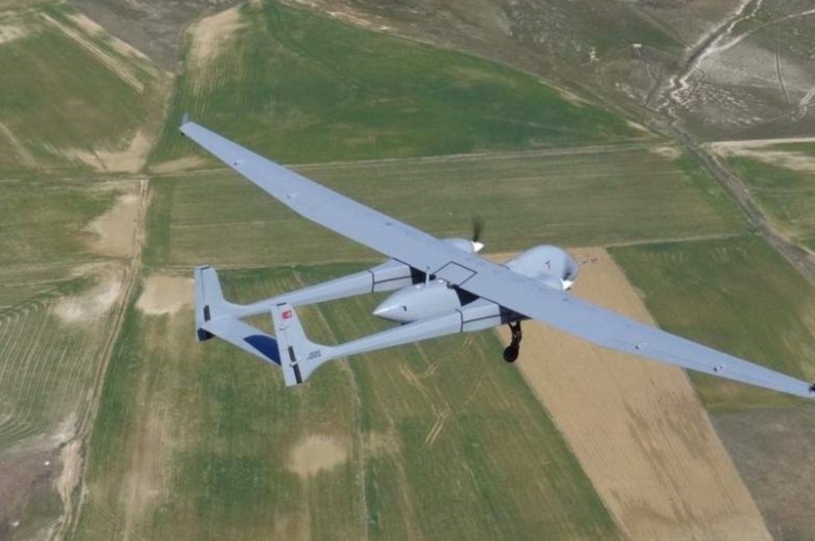 The Aksungur UAV developed by Turkish Aerospace Industries (TAI) flies over fields. (AA Photo)