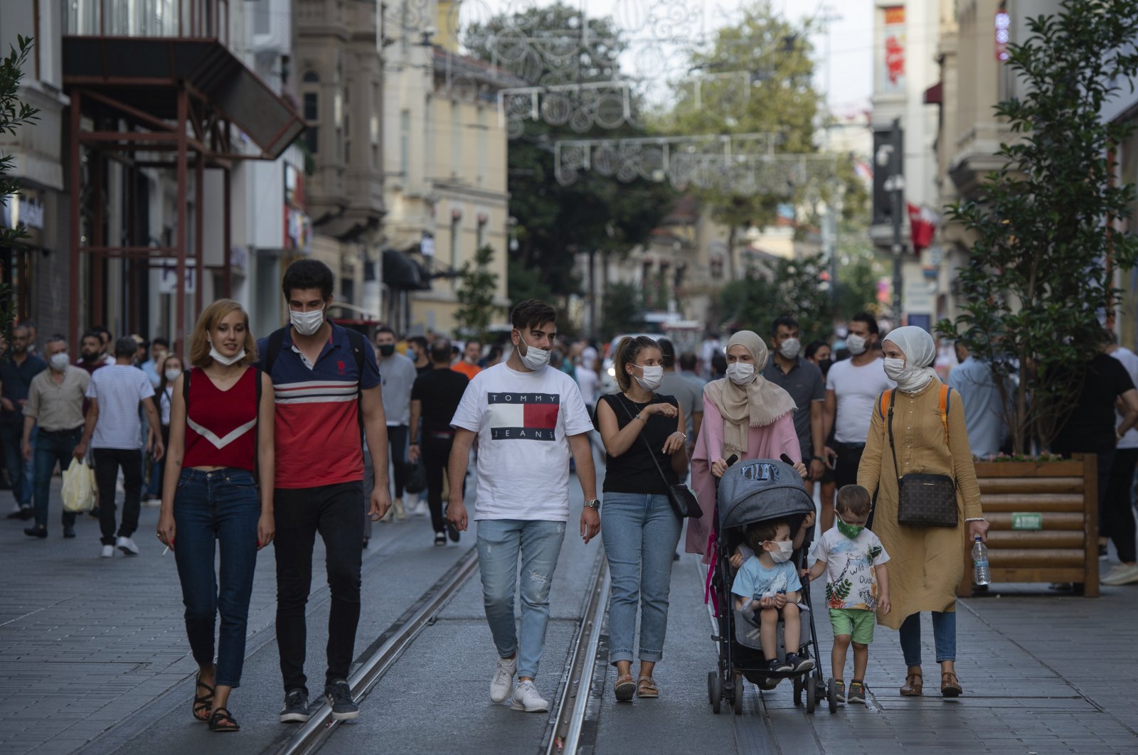 People wearing masks for protection against the spread of coronavirus, walk along Istiklal street, the main shopping street in Istanbul, Friday, Sept. 11, 2020. (AP Photo)