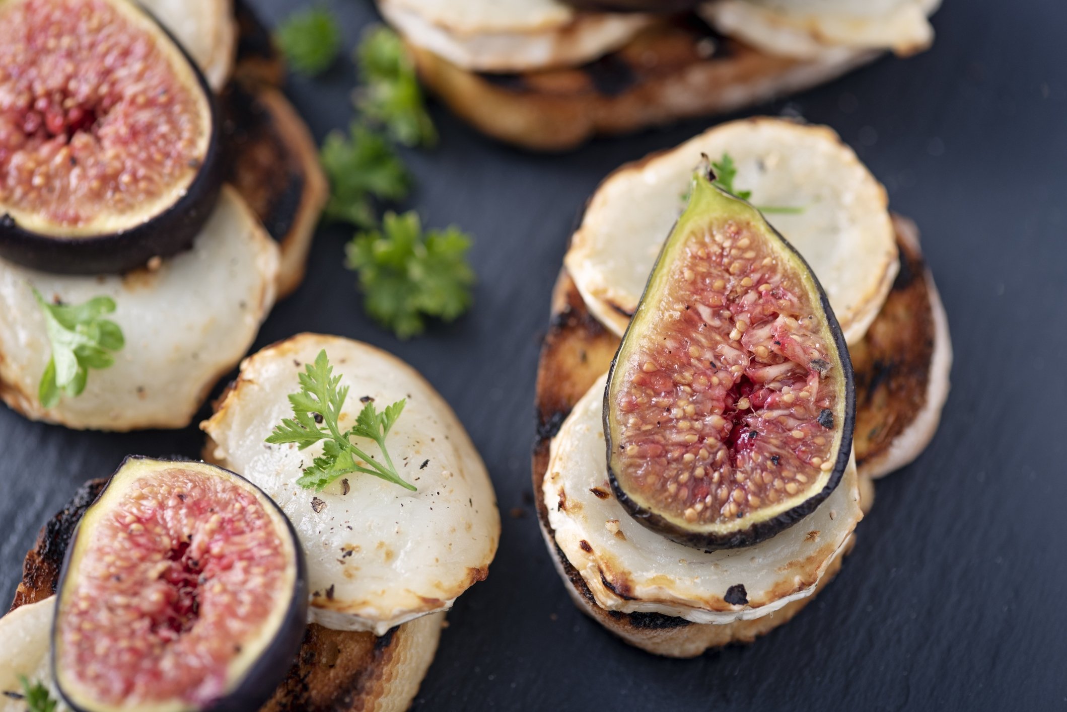 Slices of baguettes topped off with melted goat cheese and fig slices are great for fancy picnics. (iStock Photo)
