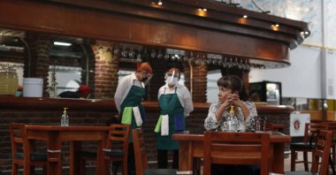 The very first customer sits at a table in Que Viva Mexico, a casual traditional food restaurant that opened its doors amid the ongoing coronavirus pandemic, in central Mexico City, Sept. 1, 2020. (AP Photo)