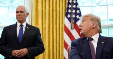 U.S. President Donald Trump looks toward Vice President Mike Pence in the Oval Office of the White House, Washington, D.C., Sept. 11, 2020. (AP Photo)