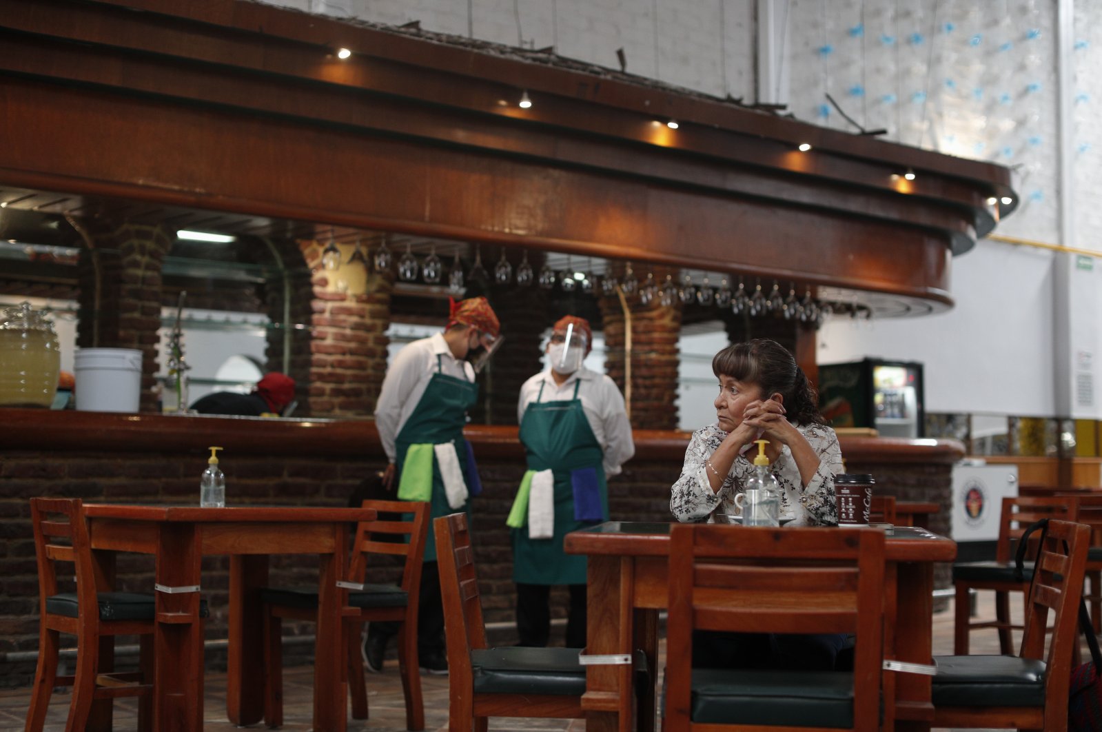 The very first customer sits at a table in Que Viva Mexico, a casual traditional food restaurant that opened its doors amid the ongoing coronavirus pandemic, in central Mexico City, Sept. 1, 2020. (AP Photo)