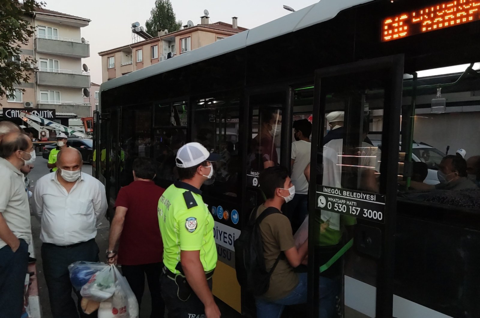 A police officer inspects for compliance with public transport rules in İnegöl district of Bursa, western Turkey, Sept. 11, 2020. (DHA Photo)