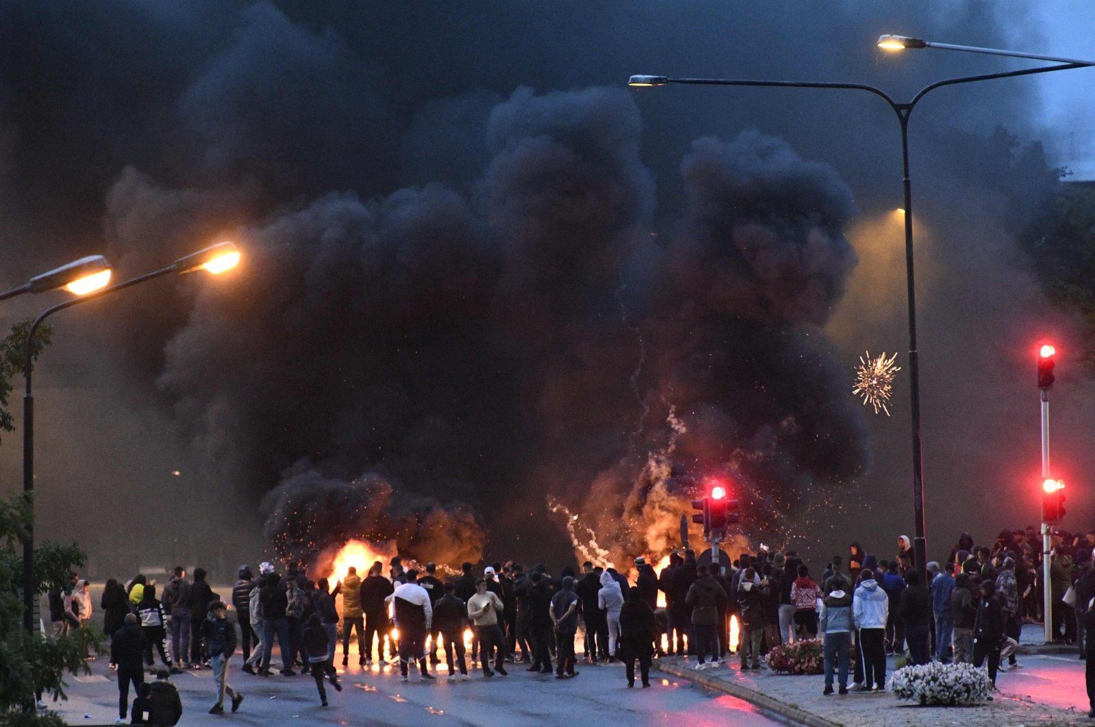 Smoke billows from burning tyres, pallets and fireworks as a few hundred protesters riot, which was sparked by the burning of a Quran, in the Rosengard neighborhood of Malmo, Sweden, Aug. 28, 2020. (AFP)