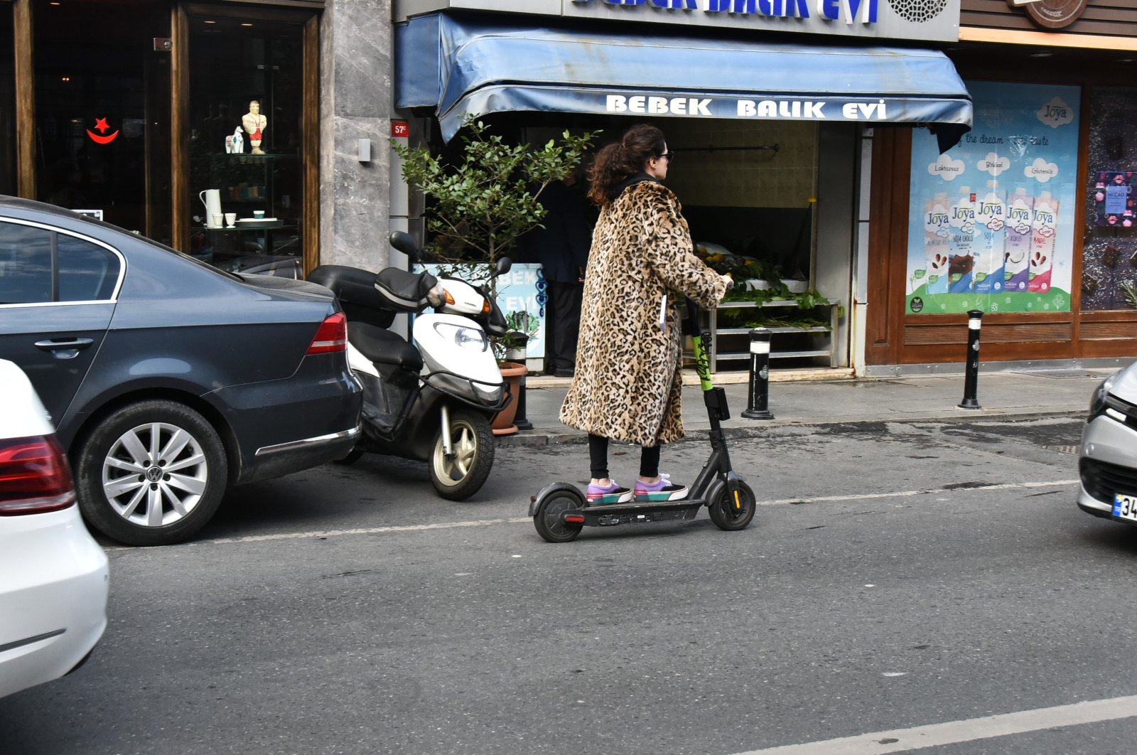 A woman rides an e-scooter in Istanbul, Turkey, Nov. 30, 2019. (Photo by Ali Keser)