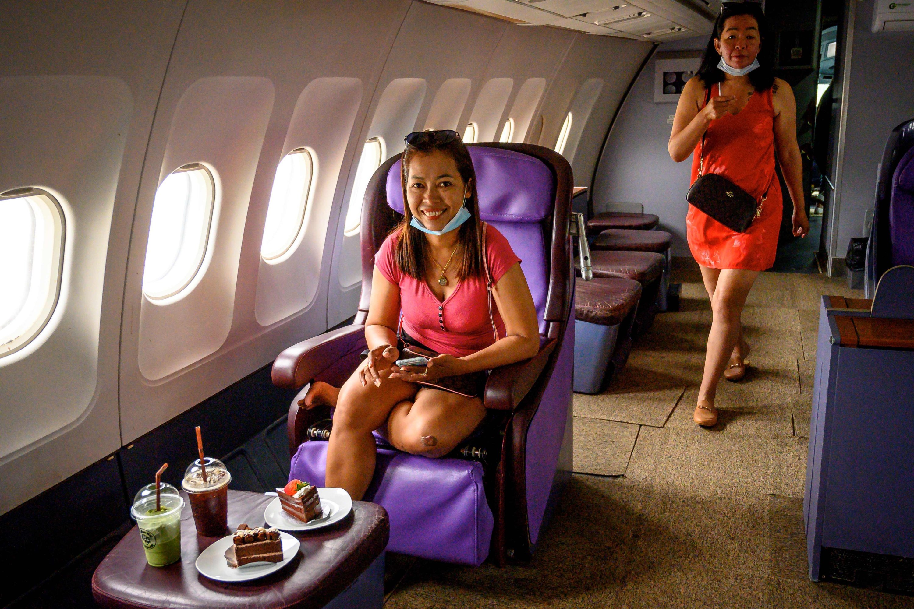This photograph taken on September 1, 2020 shows visitors enjoying business class seats in a retired Airbus 330 air-plane turned into a coffee shop at an attraction site, outside Pattaya in Chonburi province.  (AFP Photo)