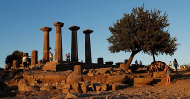 People visit the Temple of Athena in the Aegean tourist hot spot of Behramkale, Assos in Çanakkale province, western Turkey, Aug. 14, 2020. (REUTERS Photo)