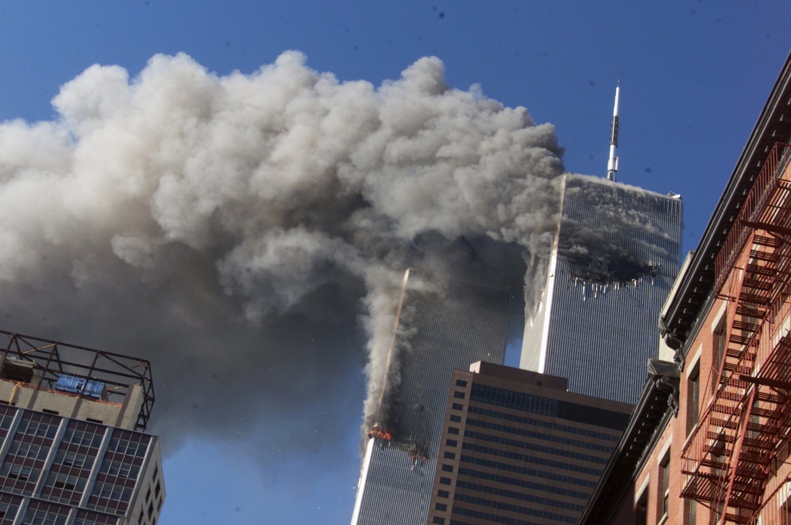 Smoke rises from the burning twin towers of the World Trade Center after hijacked planes crashed into the towers, in New York City, Sept. 11, 2001. (AP Photo)