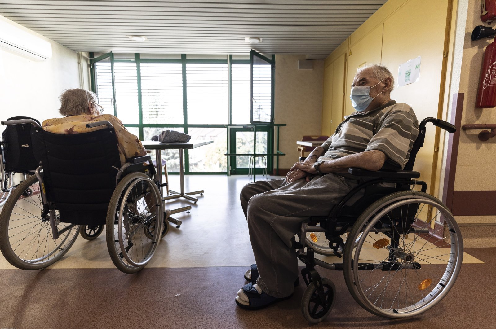 Elderly people in wheelchairs sit at a nursing home in Strasbourg, France, Aug. 19, 2020. (AP Photo)