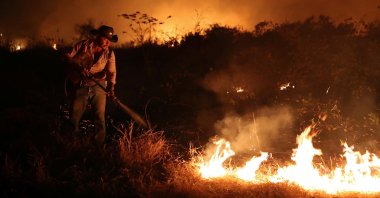 Sebastiao Junior attempts to put out a fire on a ranch in the Pantanal, the world’s largest wetland, in Pocone, Brazil.