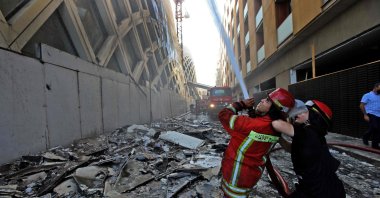 Lebanese firefighters douse the flames of a blaze that engulfed a landmark modern building, Beirut, Sept.15, 2020. (AFP Photo)