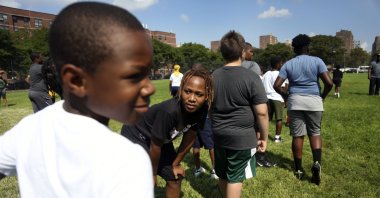Children warm up with teammates at the first football practice of the season on Sunday, Aug. 9, 2020, in Brooklyn borough of New York. (AP Photo)