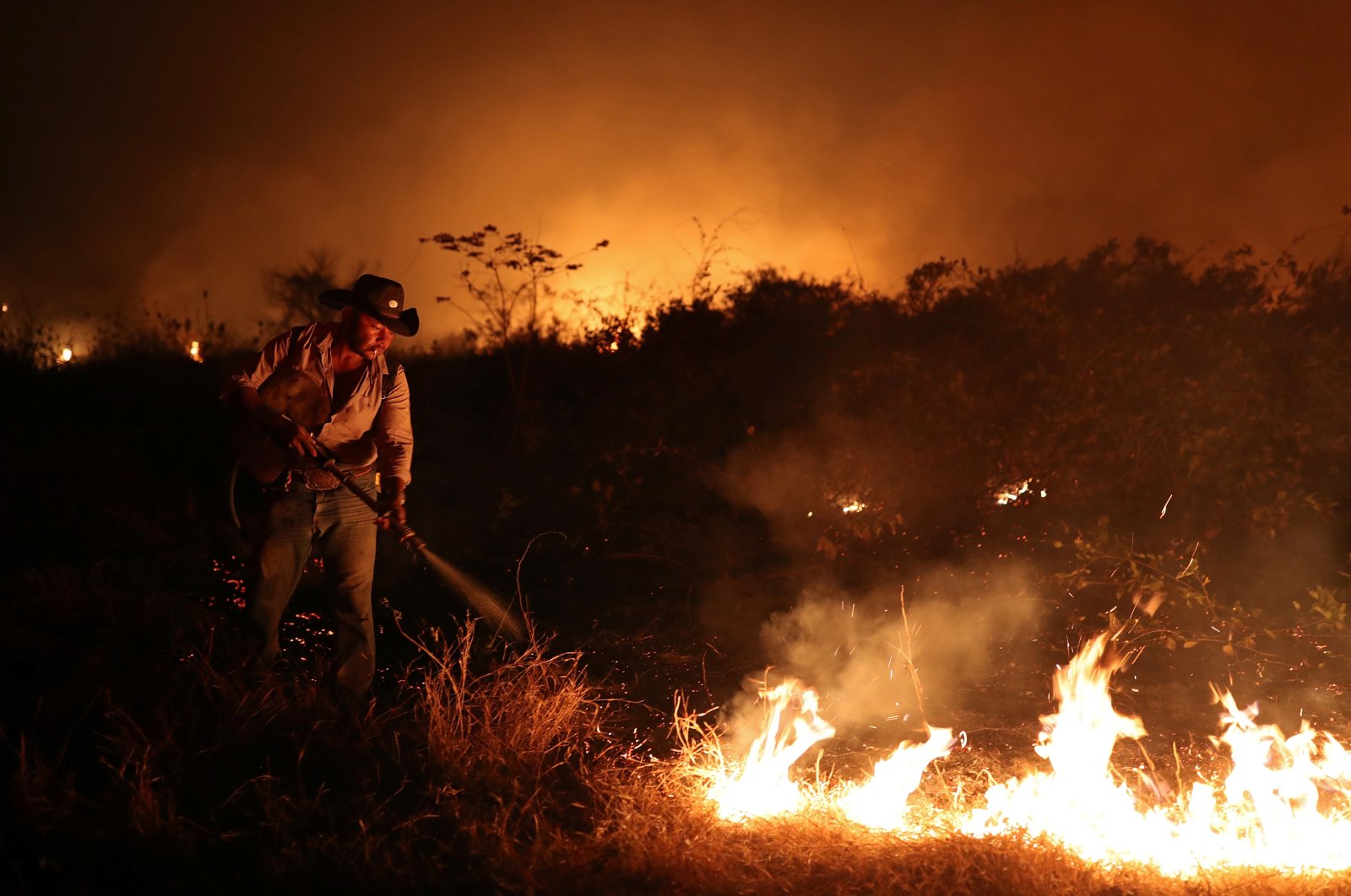 Sebastiao Junior attempts to put out a fire on a ranch in the Pantanal, the world’s largest wetland, in Pocone, Brazil.