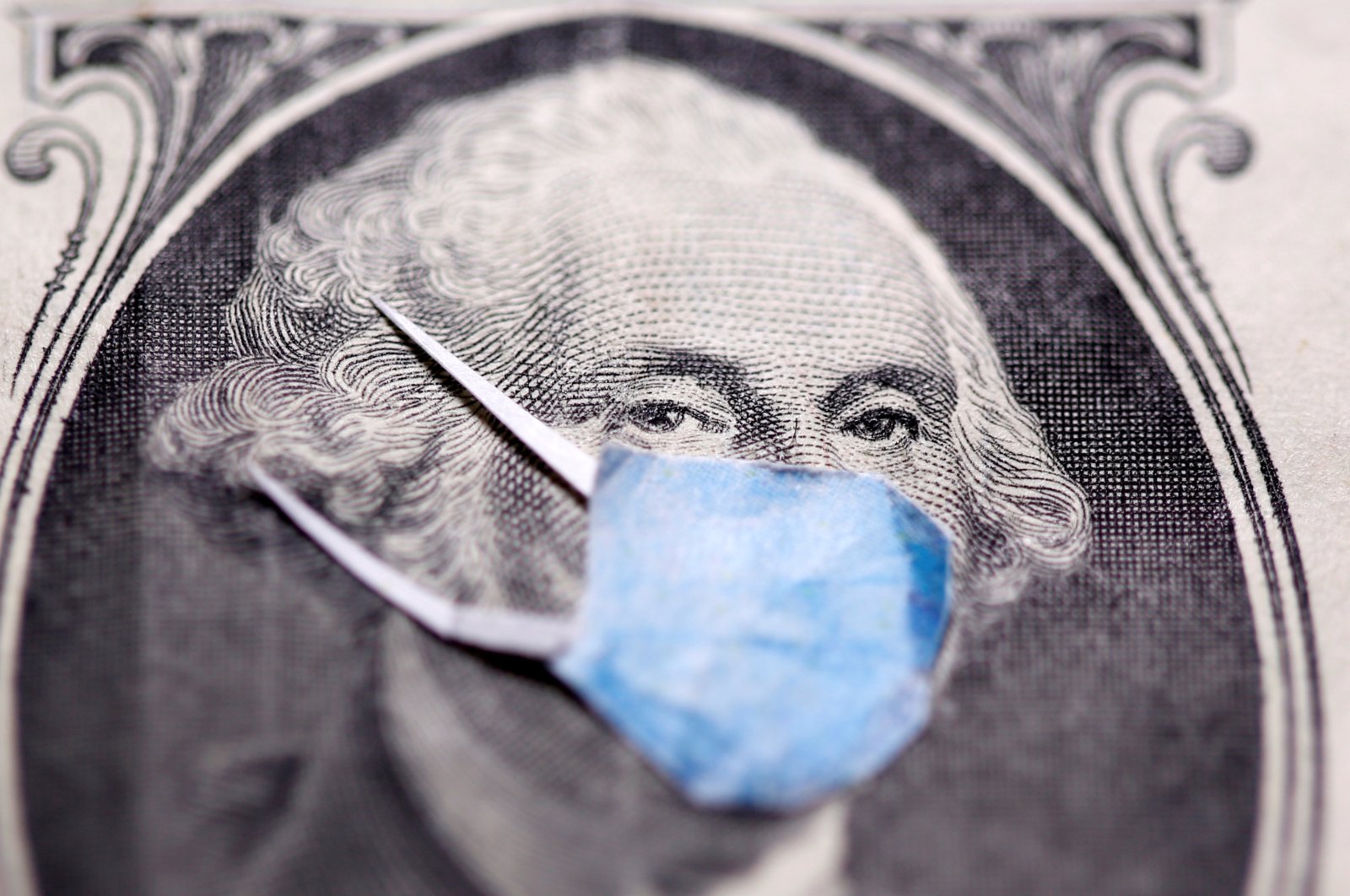 George Washington is seen with a printed medical mask on the one-dollar banknote in this illustration taken March 31, 2020. (Reuters Photo)