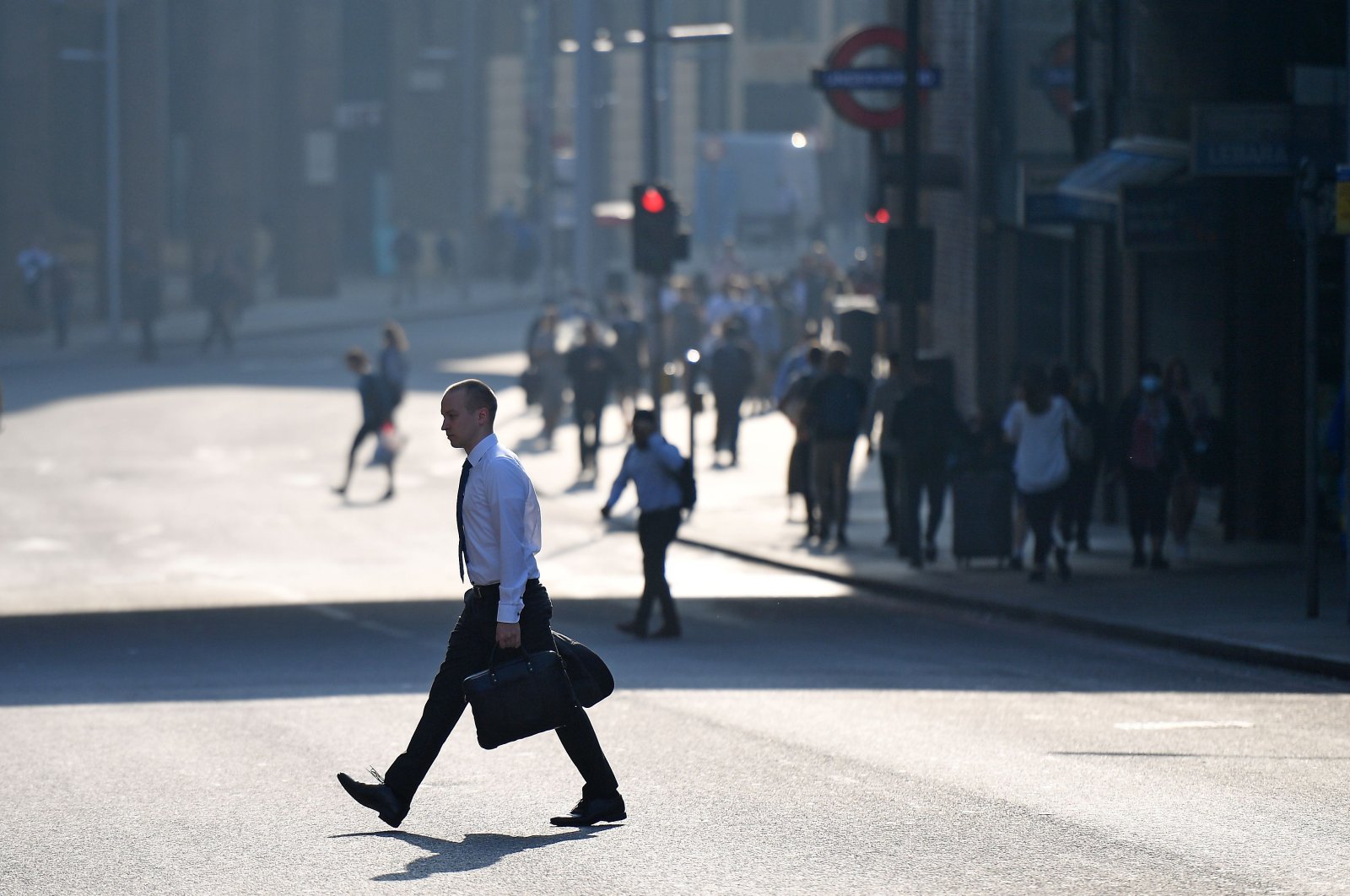 A commuter crosses a road by London Bridge in London, Britain, Sept. 15, 2020. (AFP Photo)