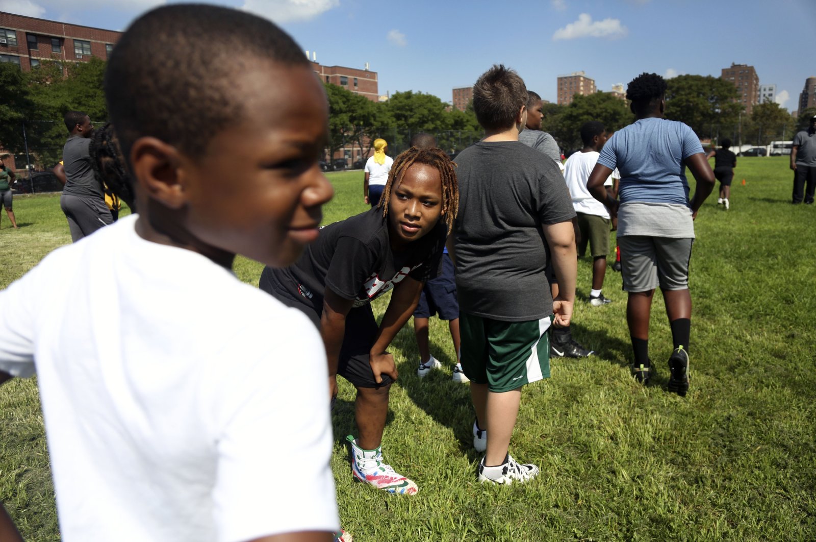 Children warm up with teammates at the first football practice of the season on Sunday, Aug. 9, 2020, in Brooklyn borough of New York. (AP Photo)