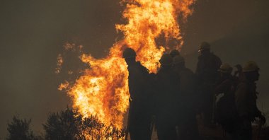 Firefighters monitor a controlled burn along Nacimiento-Fergusson Road to help contain the Dolan Fire near Big Sur, California, U.S., Sept. 11, 2020. (AP Photo)