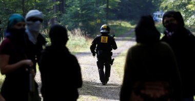 A police officer walks as the police and forest workers clear a camp at the Dannenrod forest during a protest of environmentalists against the extension of the highway Autobahn 49, in Dannenrod, Germany, Sept. 16, 2020. (Reuters Photo)
