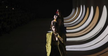 In this Feb. 25, 2020 file photo, model Kaia Gerber leads other models as they wear creations for the Saint Laurent fashion collection during Women's fashion week Fall/Winter 2020/21 presented in Paris. (AP Photo)