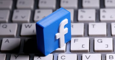 A 3D-printed Facebook logo is seen placed on a keyboard in this illustration taken March 25, 2020. (Reuters Photo)