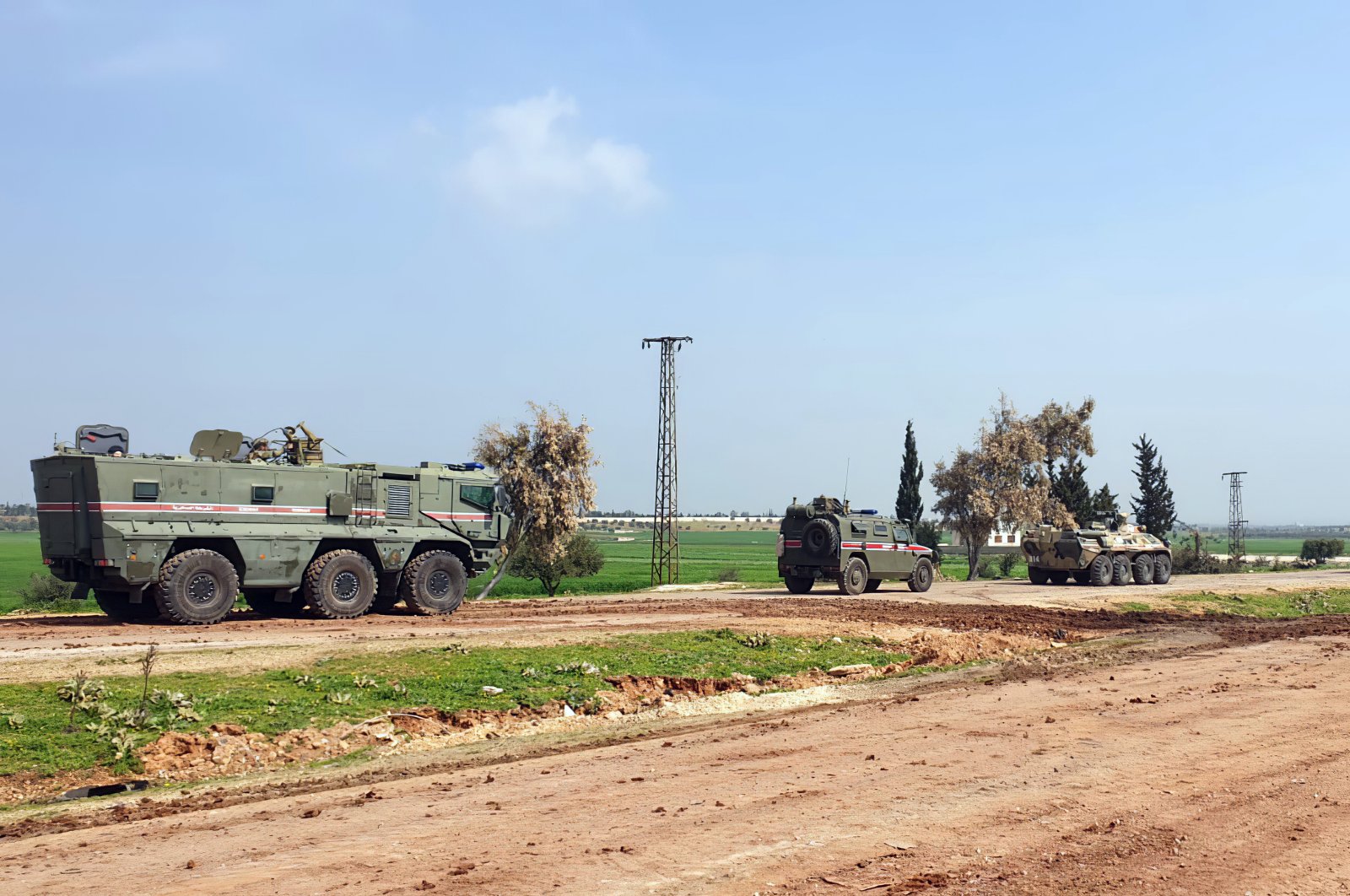 Turkish and Russian troops patrol on the M4 highway, which runs east-west through Idlib province, northwestern Syria, March 15, 2020. (Turkish Defense Ministry via AP)