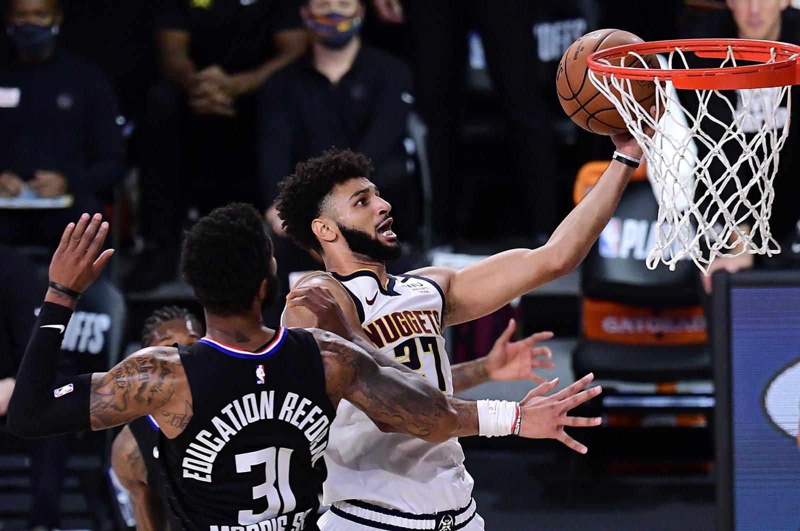 Denver Nuggets' Jamal Murray (R) drives to the basket against LA Clippers' Marcus Morris during an NBA game in Lake Buena Vista, Florida, U.S., Sept. 15, 2020. (AFP Photo)
== FOR NEWSPAPERS, INTERNET, TELCOS & TELEVISION USE ONLY ==