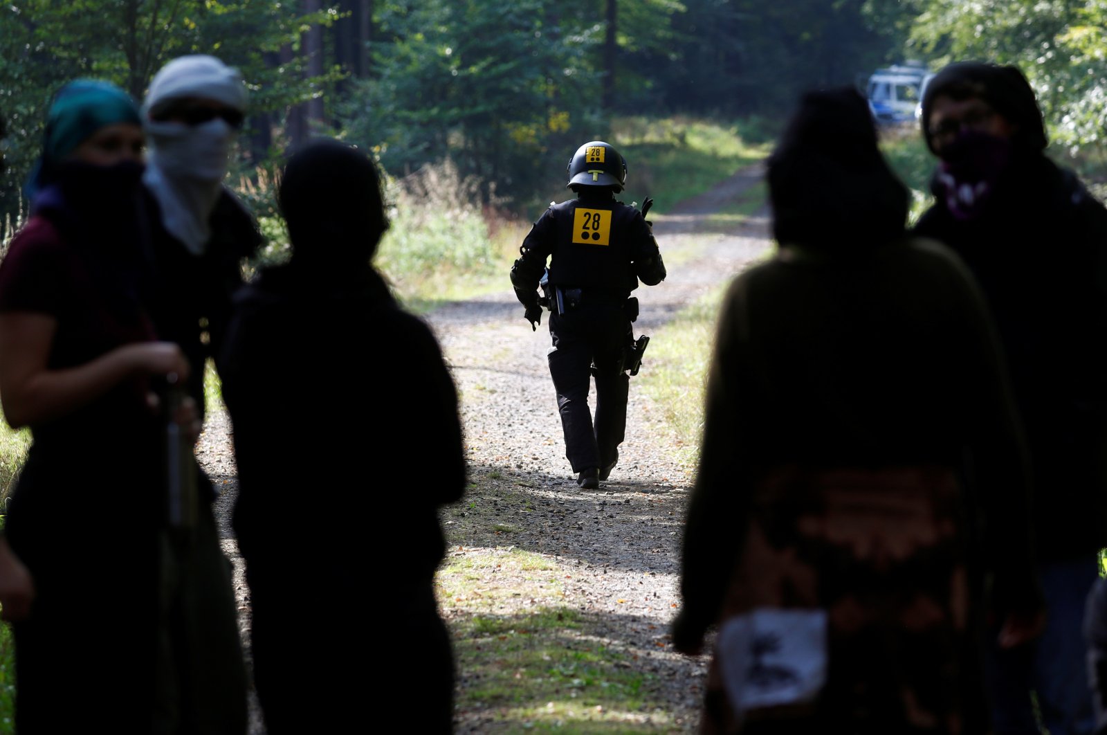 A police officer walks as the police and forest workers clear a camp at the Dannenrod forest during a protest of environmentalists against the extension of the highway Autobahn 49, in Dannenrod, Germany, Sept. 16, 2020. (Reuters Photo)