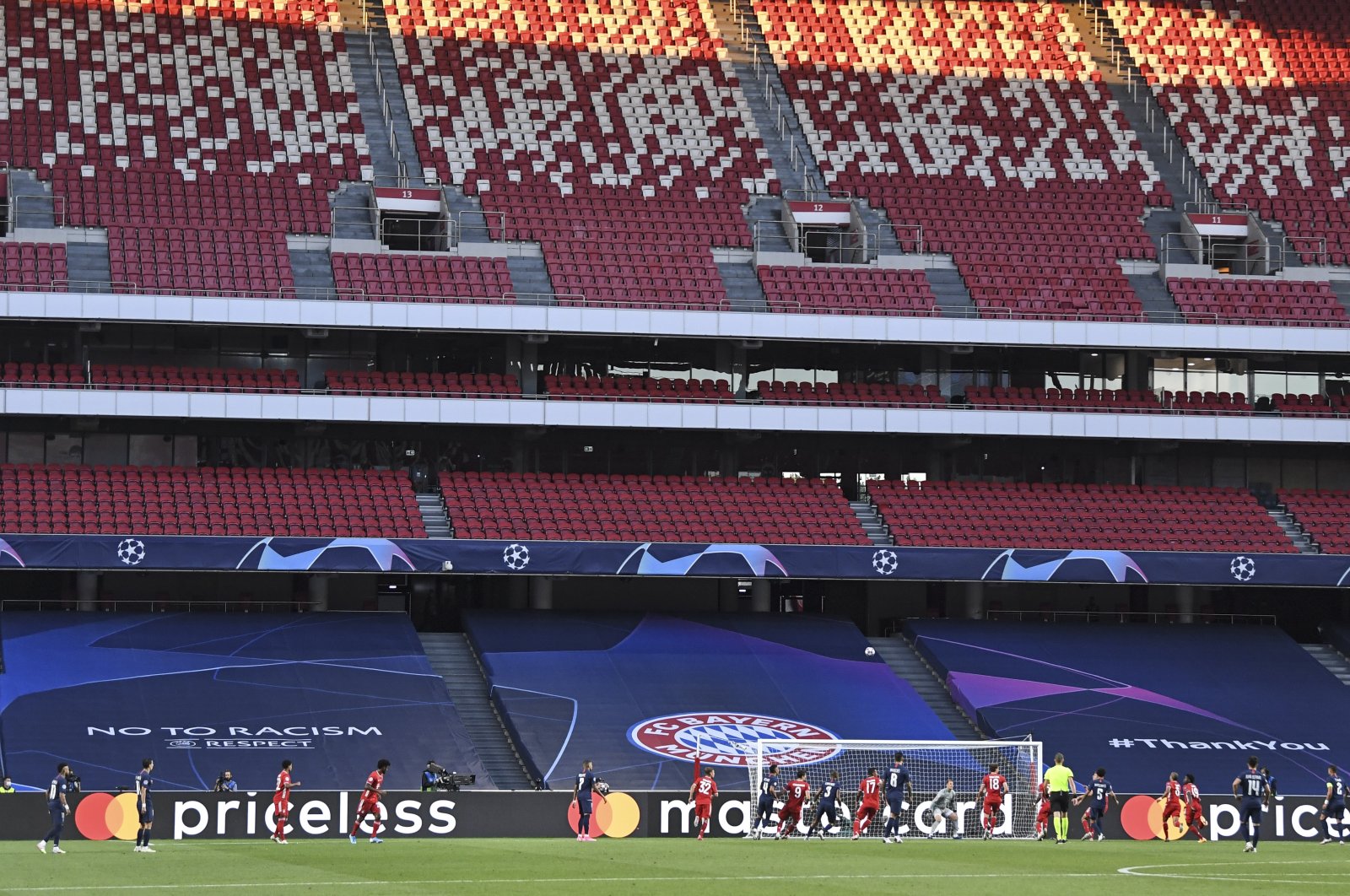 Players challenge for the ball in front of empty stands during the Champions League final match between Paris Saint-Germain and Bayern Munich in Lisbon, Portugal, Aug. 23, 2020. (AP Photo)