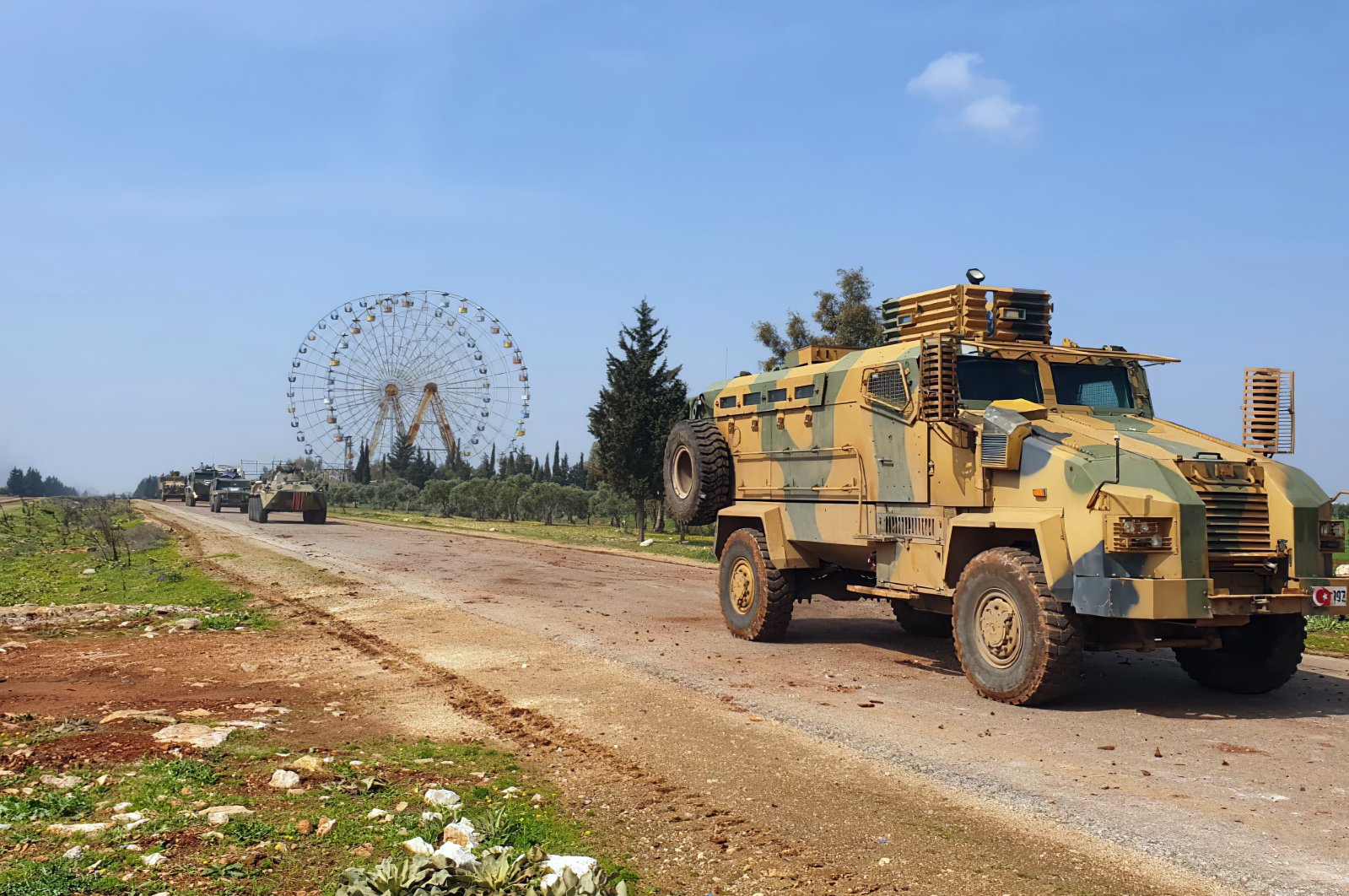 Turkish and Russian troops patrol on the M4 highway, which runs east-west through Idlib province, Syria, March 15, 2020. (AP Photo)