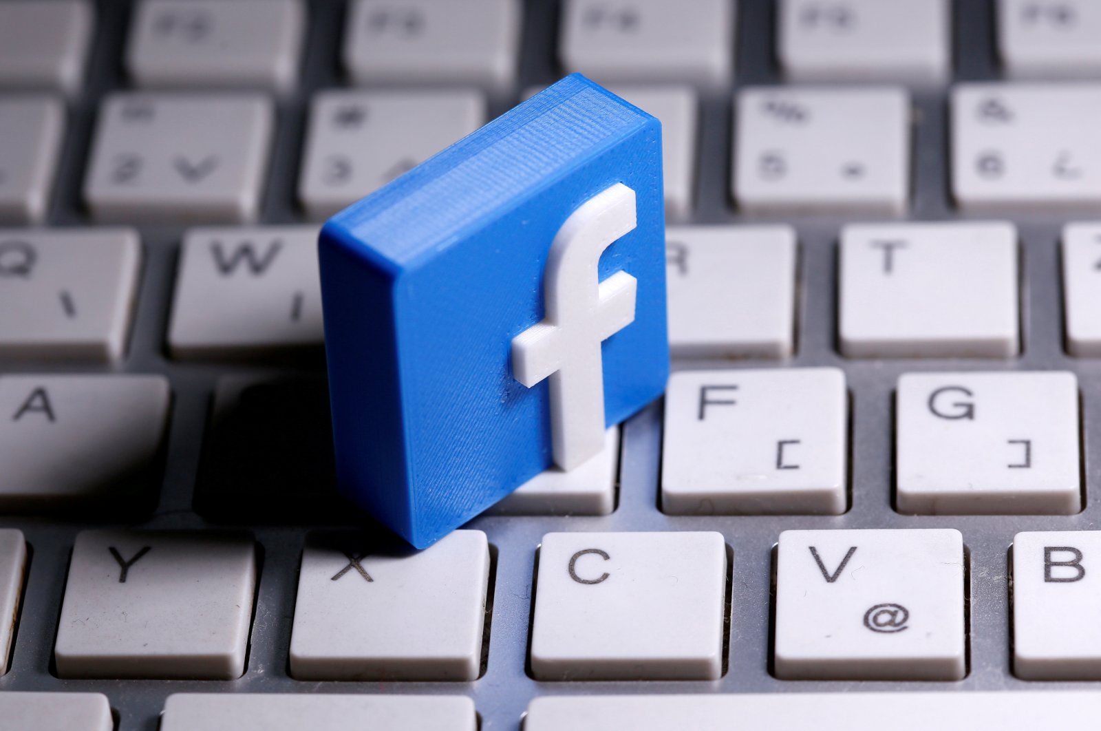 A 3D-printed Facebook logo is seen placed on a keyboard in this illustration taken March 25, 2020. (Reuters Photo)