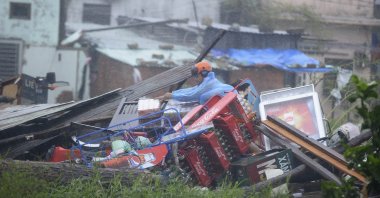 A man sorts through the remains of his home, which collapsed because of Typhoon Nari, in Danang, Vietnam, Oct. 15, 2013. (Reuters Photo)