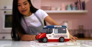 Alison Chan, co-owner of Dear Harley Cake Studio, shows one of the illusion cakes designed to look like a local mobile ice cream truck at the studio in Hong Kong, China, Aug. 25, 2020. (Reuters Photo)