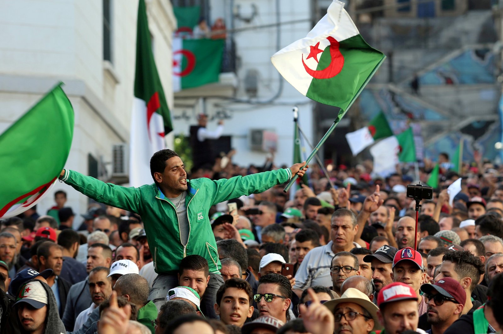 Demonstrators carry national flags during a protest in the capital Algiers, Algeria, Oct. 25, 2019. (REUTERS Photo)