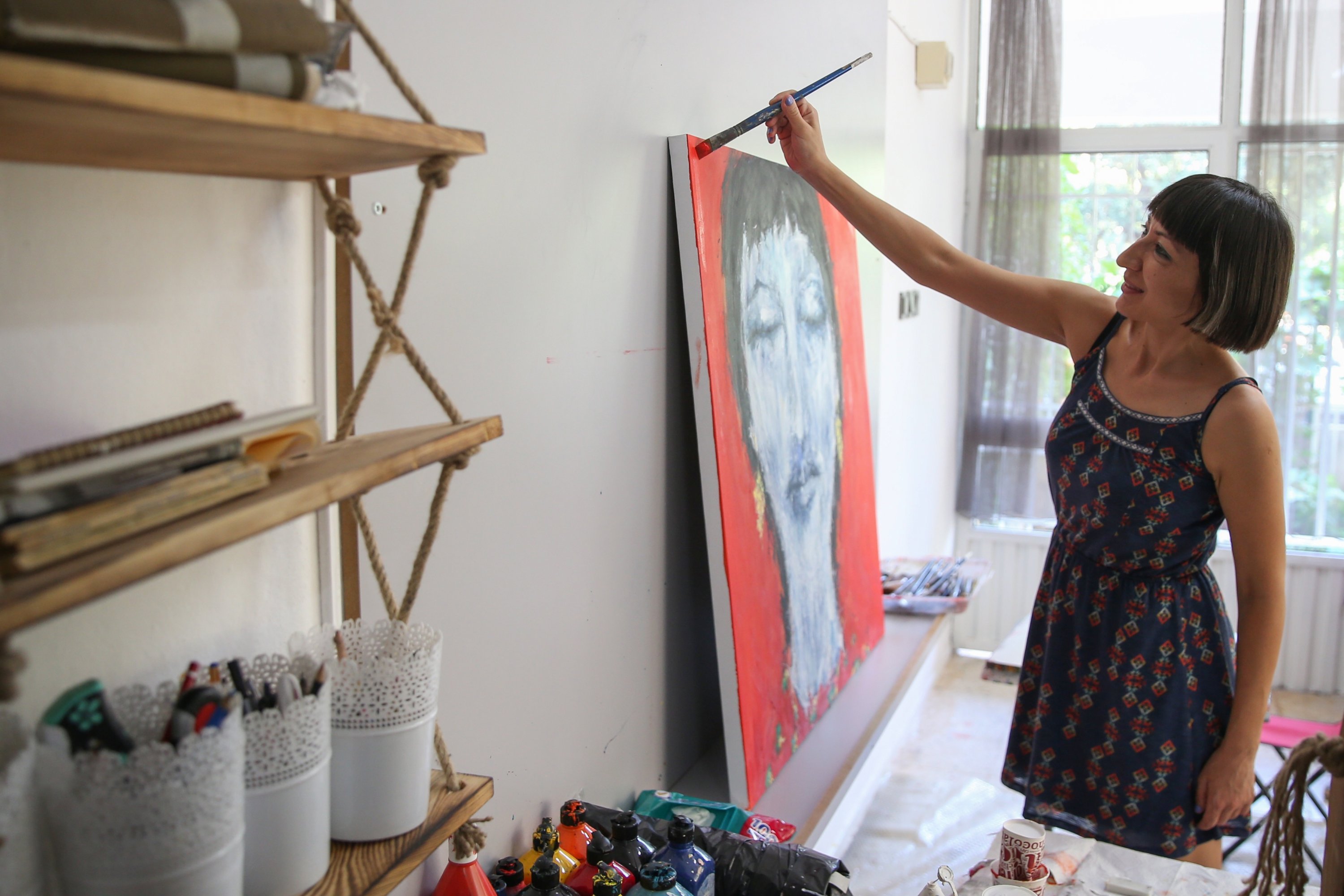 Deniz Karakurt Şekerci paints in her workshop, Antalya, southern Turkey, Sept. 17, 2020. (AA Photo)