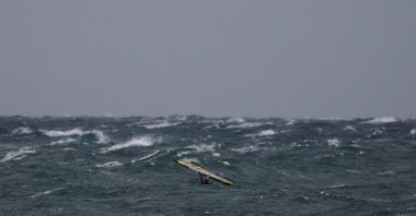 A windsurfer tries to stand on his board as strong winds hit the port town of Rafina, near Athens, Greece, Sept. 27, 2018. (Reuters Photo)