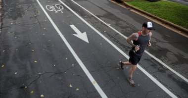 Former ultra-marathoner Josh Wiese runs along Pershing Avenue in University City, Missouri, U.S., Aug. 3, 2020. He can no longer complete a 2-mile run without stopping after contracting what was likely COVID-19 in March. (Christian Gooden/St. Louis Post-Dispatch/TNS/ABACAPRESS.COM via REUTERS)