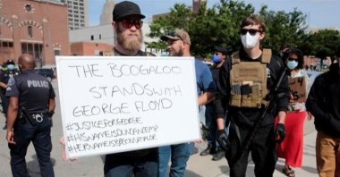 Armed men, one carrying a "The Boogaloo stands with George Floyd" sign, are seen in Detroit, Michigan in this undated photo. (REUTERS Photo)