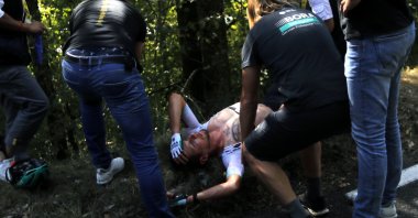 Lukas Postlberger of Austria is treated by medics during stage 19 of the Tour de France cycling race over 166 kilometers (103 miles), with the start in Bourg-en-Bresse and finish in Champagnole, France, Sept. 18, 2020. (AP Photo)