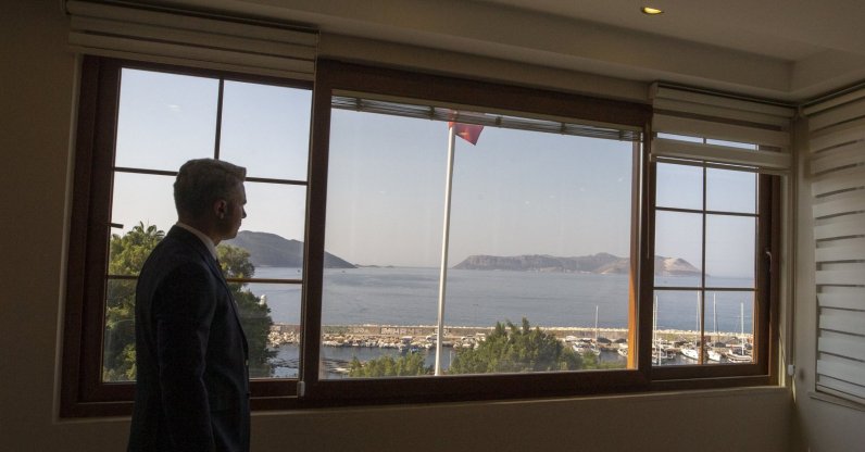 Kaş District Governor Şaban Arda Yazıcı looks at the island of Kastellorizo from the window of his office in Kaş, Antalya province, southern Turkey, Sept. 18, 2020. (AA Photo)
