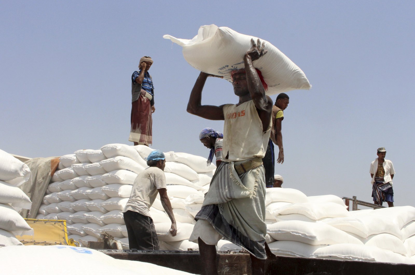 In this file photo, men deliver U.N. World Food Programme (WFP) aid in Aslam, Hajjah, Yemen on Sept. 21, 2018. (AP Photo)