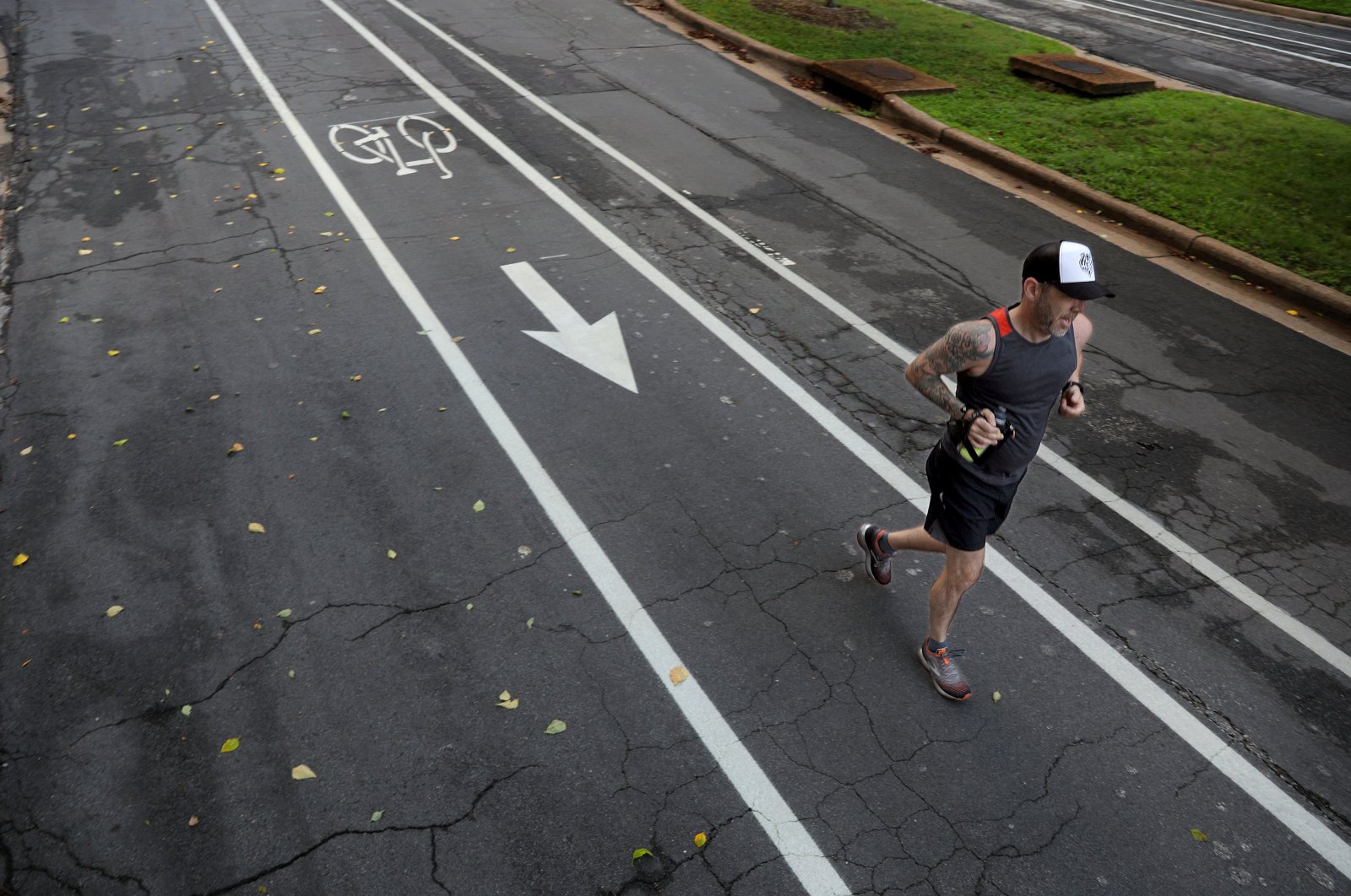 Former ultra-marathoner Josh Wiese runs along Pershing Avenue in University City, Missouri, U.S., Aug. 3, 2020. He can no longer complete a 2-mile run without stopping after contracting what was likely COVID-19 in March. (Christian Gooden/St. Louis Post-Dispatch/TNS/ABACAPRESS.COM via REUTERS)