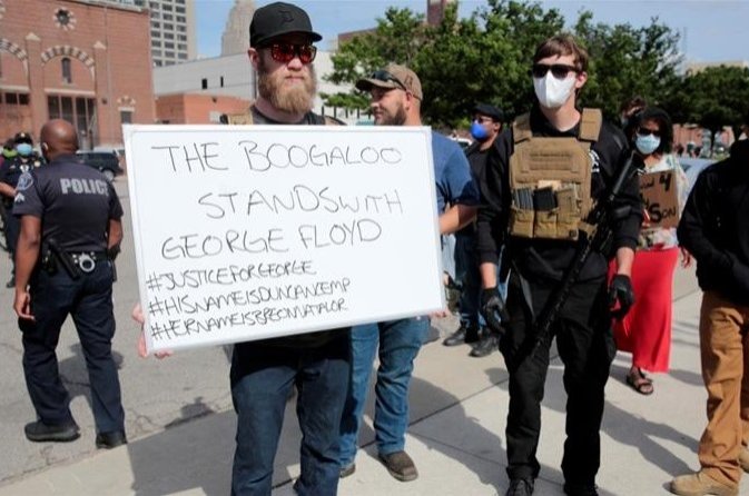 Armed men, one carrying a "The Boogaloo stands with George Floyd" sign, are seen in Detroit, Michigan in this undated photo. (REUTERS Photo)