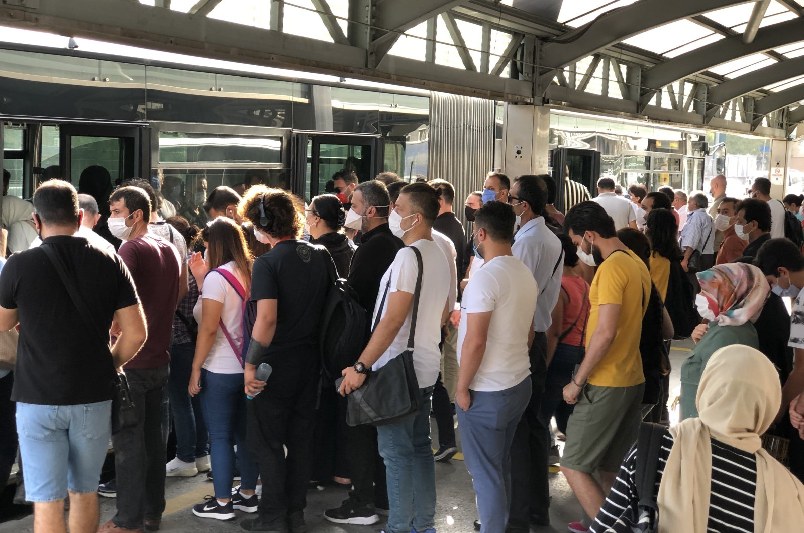 People form a queue as they wait to get on a metrobus in Istanbul, Turkey, Sept. 16, 2020. (IHA Photo)