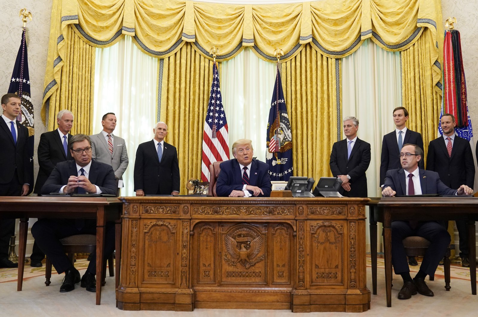 U.S. President Donald Trump (C) speaks after participating in a signing ceremony with Serbian President Aleksandar Vucic (L) and Kosovar Prime Minister Avdullah Hoti in the Oval Office of the White House, Friday, Sept. 4, 2020, in Washington. (AP Photo)