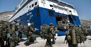 Greek soldiers prepare to board a ferry at the port of the tiny Greek island of Kastellorizo (Megisti-Meis), the most southeastern inhabited Greek island in the Dodecanese, situated two kilometers off the south coast of Turkey. (AFP Photo)